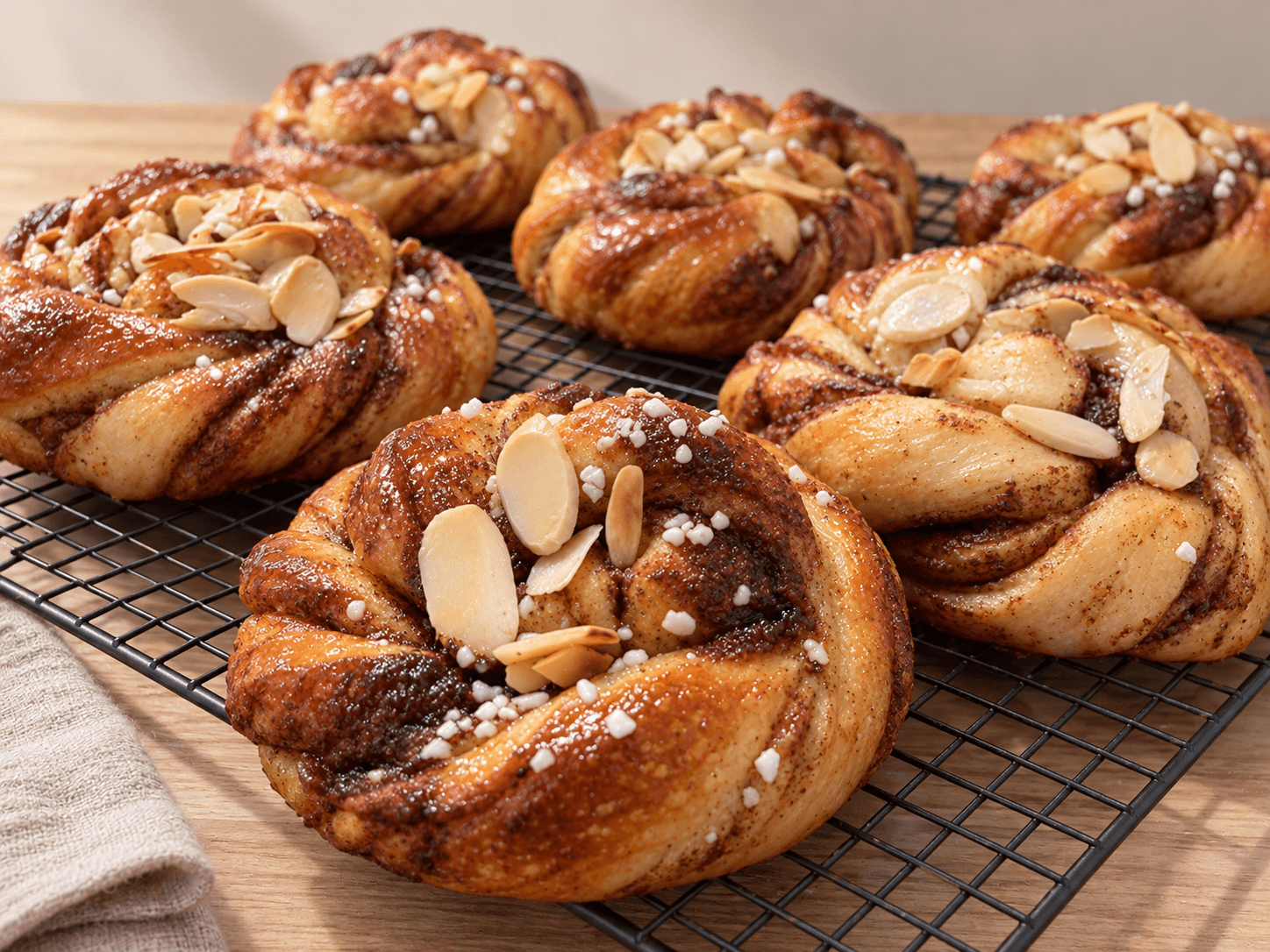 Freshly baked Swedish kanelbullar with pearl sugar and almond